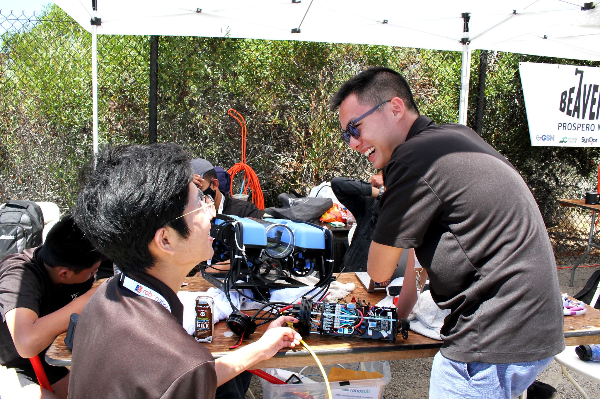 Team working on AUV at competition tent