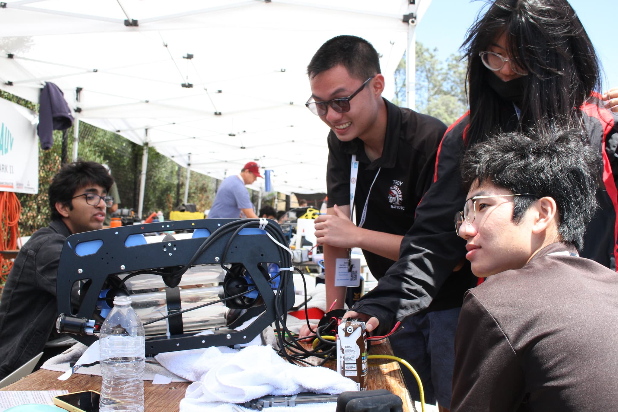 Team members around AUV at competition