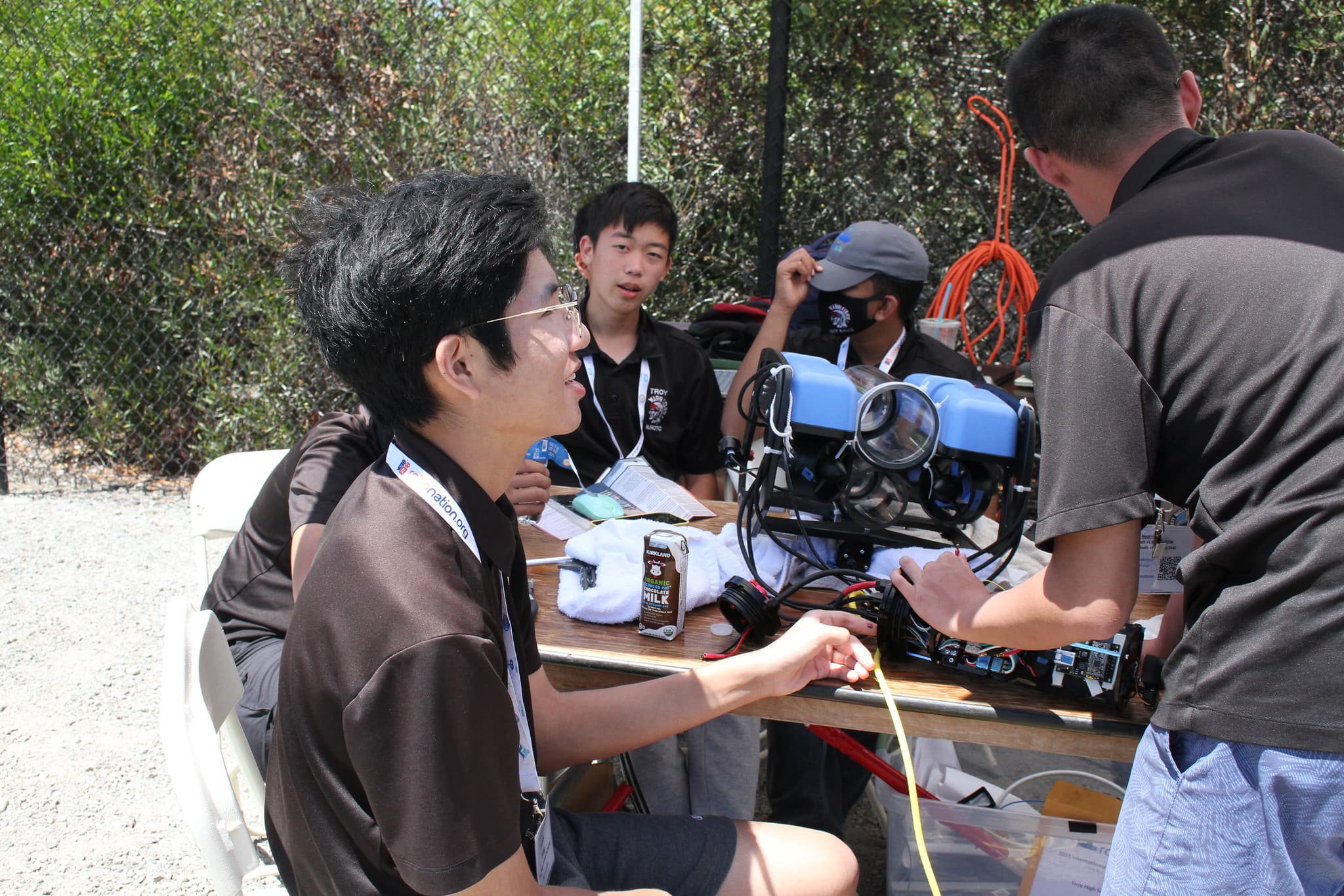 Team members discussing next to AUV
