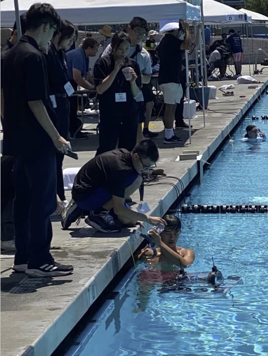 AUV being lowered into competition pool