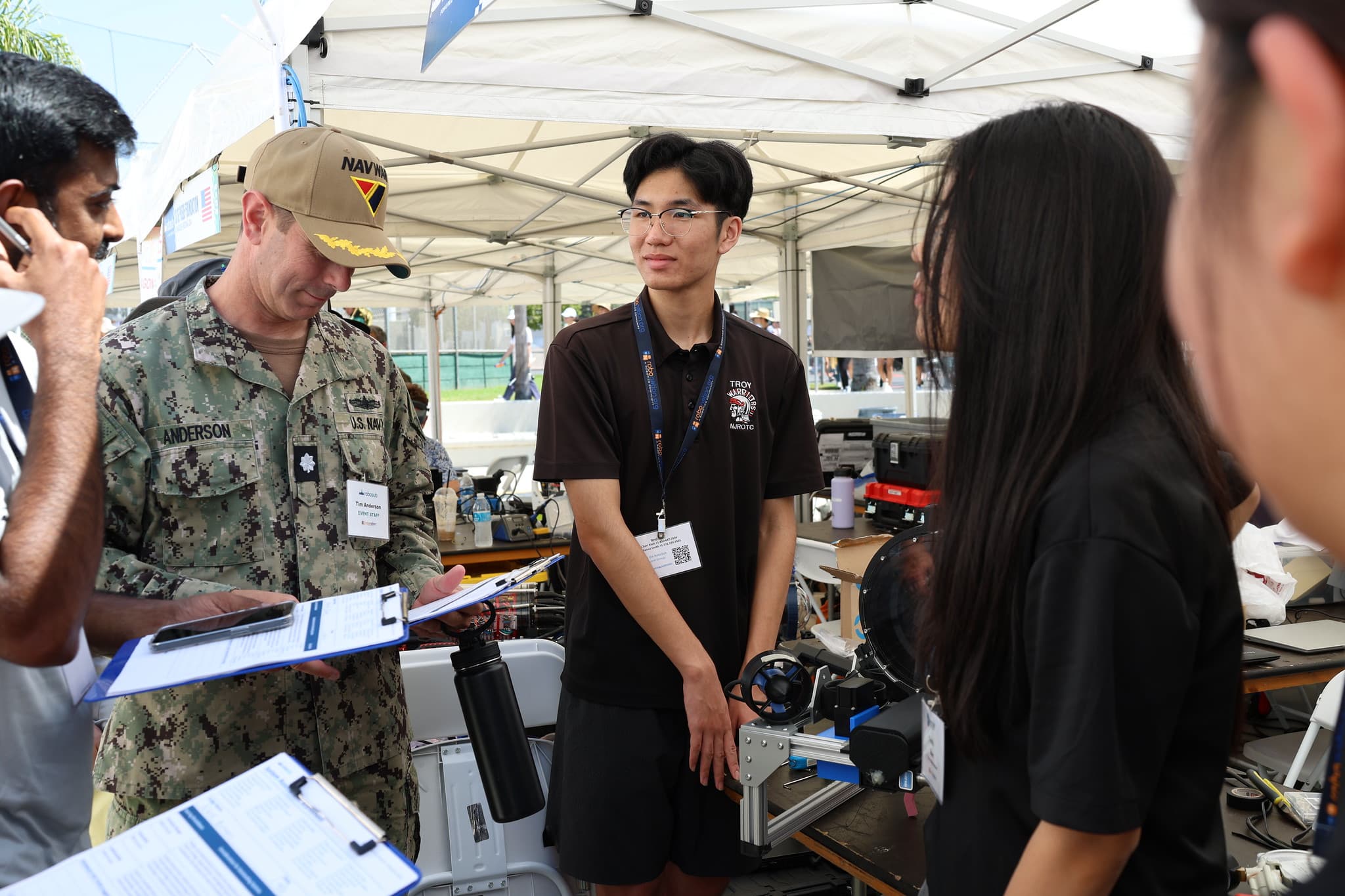 Team speaking with Navy officer at judging