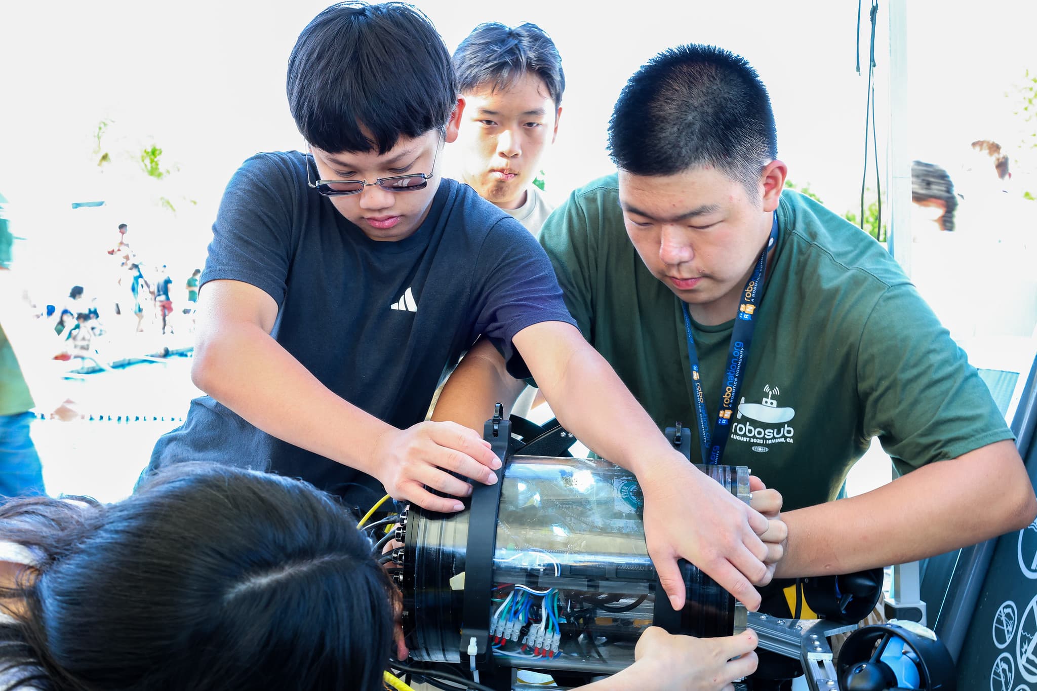 Team members working on AUV at competition tent