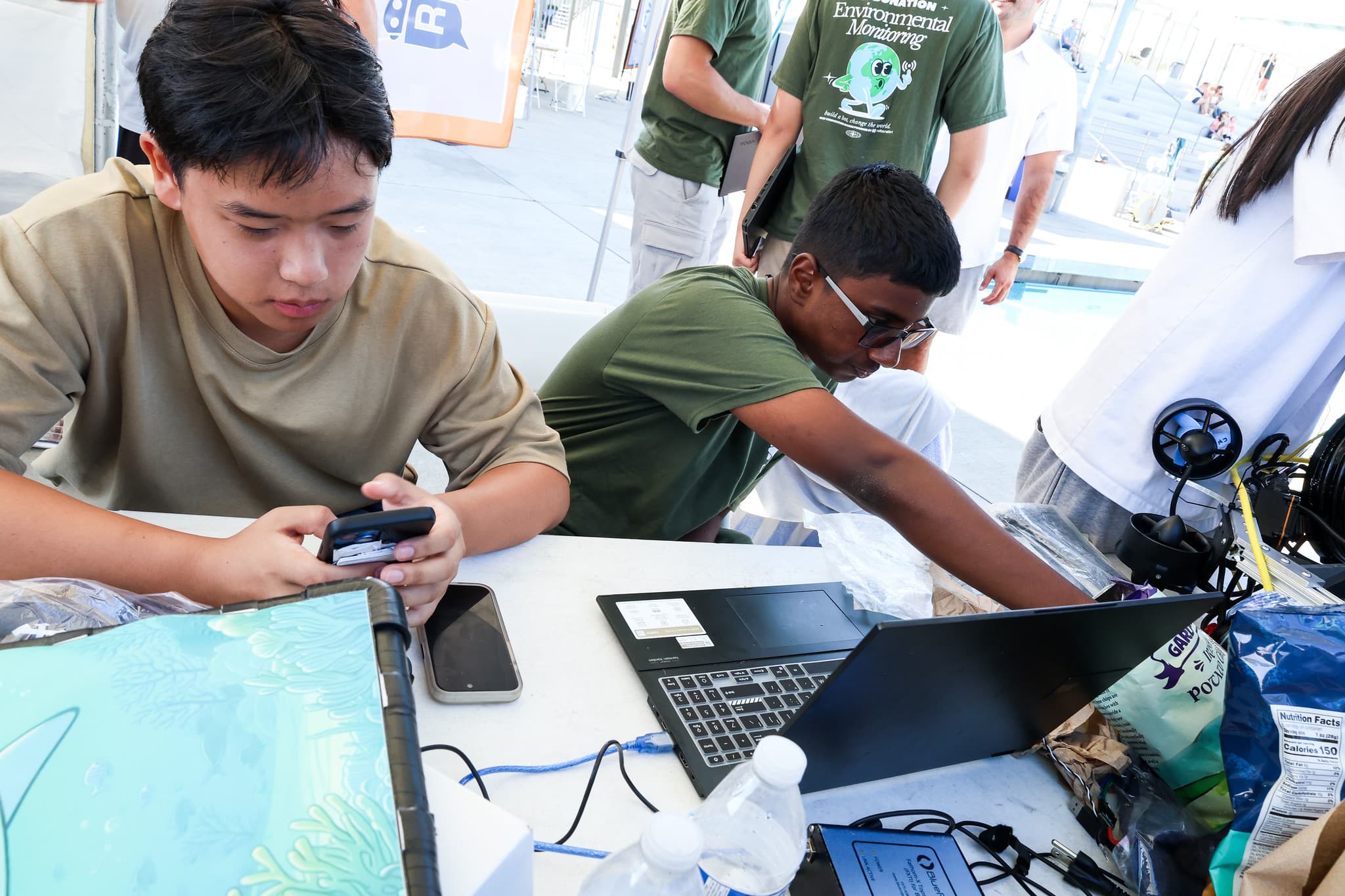 Team debugging at the competition tent